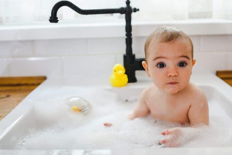 bathing baby in the kitchen sink