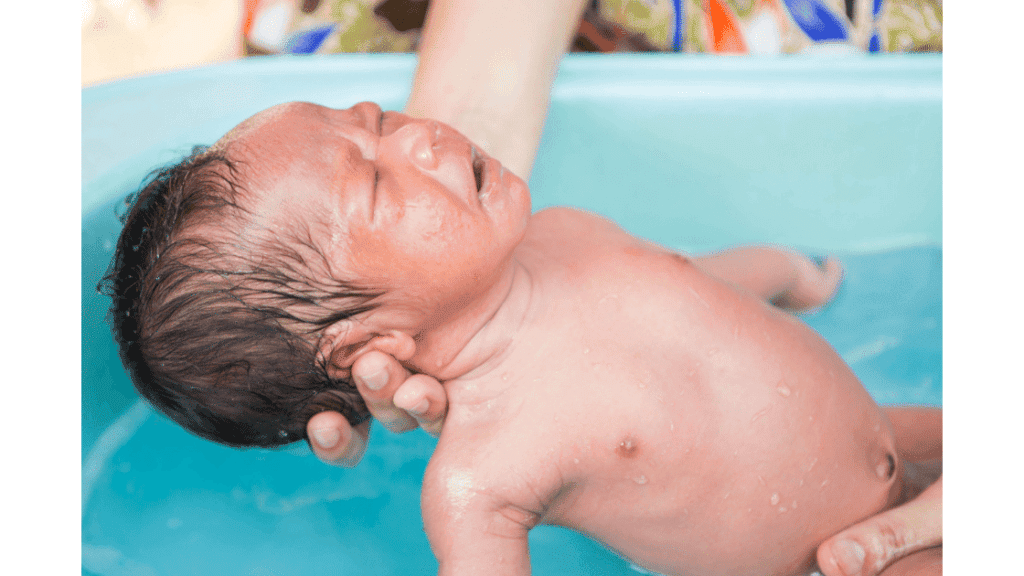 newborn baby crying while bathing